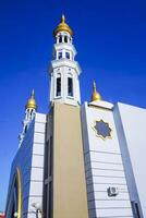 The splendor of the mosque and its towering minaret under the blue sky creates a stunning view photo