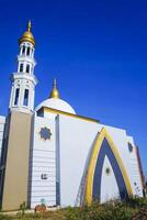 The splendor of the mosque and its towering minaret under the blue sky creates a stunning view photo