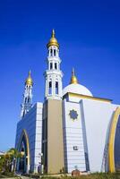 The splendor of the mosque and its towering minaret under the blue sky creates a stunning view photo