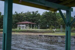 rich gazebo on the edge of the lake in the afternoon photo
