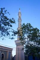 The mosque's minaret rises high against the blue sky, adding to the atmosphere of majesty photo