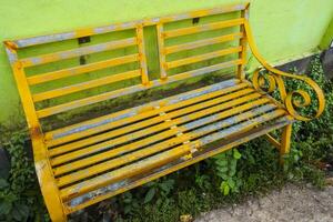 yellow waiting chairs on the side of the road, suitable for a relaxing place photo