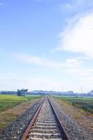The view of the train tracks in the morning in rural Indonesia creates a romantic atmosphere photo