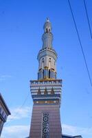 The mosque's minaret rises high against the blue sky, adding to the atmosphere of majesty photo