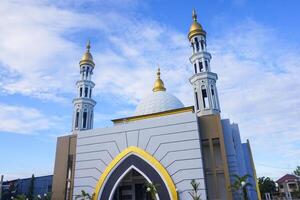 The splendor of the mosque and its towering minaret under the blue sky creates a stunning view photo