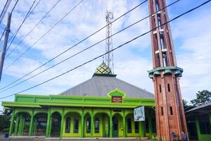 The splendor of the mosque and its towering minaret under the blue sky creates a stunning view photo