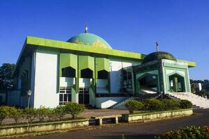 View of a mosque and its dome with a garden in its yard, the view of the mosque and its dome looks out, creating a stunning view photo