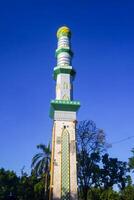 The mosque's minaret rises high against the blue sky, adding to the atmosphere of majesty photo