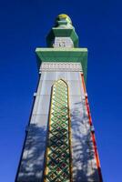 The mosque's minaret rises high against the blue sky, adding to the atmosphere of majesty photo