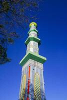 The mosque's minaret rises high against the blue sky, adding to the atmosphere of majesty photo