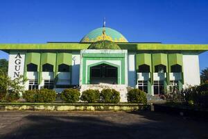 View of a mosque and its dome with a garden in its yard, the view of the mosque and its dome looks out, creating a stunning view photo