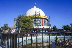 View of a mosque and its dome with a garden in its yard, the view of the mosque and its dome looks out, creating a stunning view photo