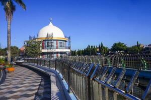 View of a mosque and its dome with a garden in its yard, the view of the mosque and its dome looks out, creating a stunning view photo