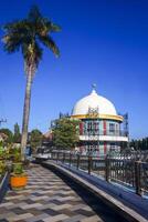 View of a mosque and its dome with a garden in its yard, the view of the mosque and its dome looks out, creating a stunning view photo