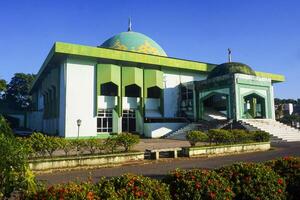 View of a mosque and its dome with a garden in its yard, the view of the mosque and its dome looks out, creating a stunning view photo