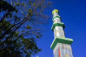 The mosque's minaret rises high against the blue sky, adding to the atmosphere of majesty photo