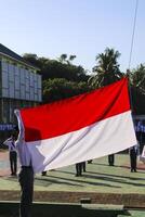 Pangkep, Indonesia, March 15 2023. Indonesia's red and white flag fluttered as students were pulling a ceremony photo