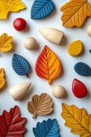 Colorful autumn leaves and wooden toys arranged on a blue background in fall setting photo