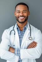 Smiling doctor in a lab coat with stethoscope against a gray background photo