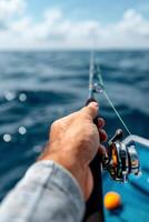 Fishing Off The Coast With A Rod In Hand Under Clear Skies photo