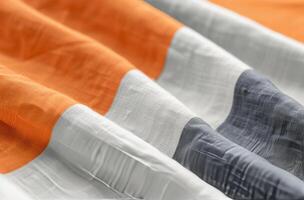 Vibrant Fabric With Orange and Gray Stripes on a Soft Surface photo