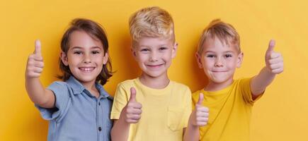 Happy Boy Giving Thumbs Up Against Bright Yellow Background photo