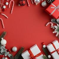 Festive Christmas Gifts and Ornaments on Red Background With Pine and Candy Canes photo