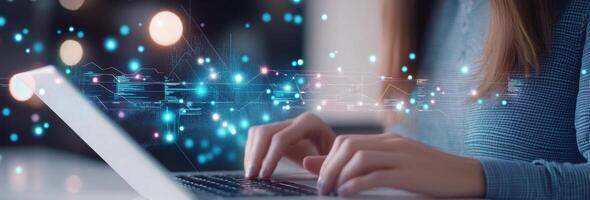 Person typing on a laptop while digital data visualizations float in the air at night photo