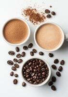 Coffee preparation with grounded beans, cocoa powder, and brewed drink on a white surface photo