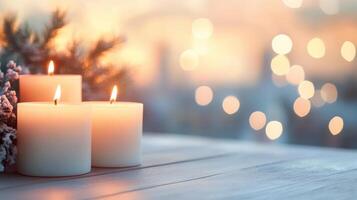 Three lit candles on a wooden table with a soft, blurred background at dusk photo