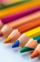 Brightly colored pencils arranged in a vibrant pattern on a wooden surface photo