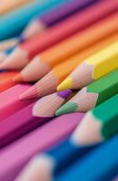 Brightly colored pencils arranged in a vibrant pattern on a wooden surface photo