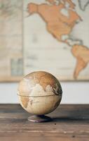 Vintage globe on stand with world map in the background photo