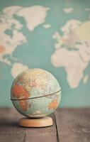 Vintage globe on stand with world map in the background photo