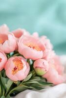 Fresh bouquet of pink peonies in a sunlit room with soft background photo
