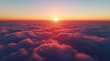 Vibrant sunset above fluffy clouds seen from a high vantage point photo