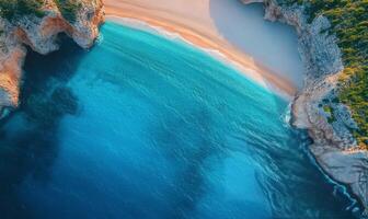 Serene coastline with sandy beach and turquoise waters during sunset in Algarve photo