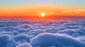 Vibrant sunset above fluffy clouds seen from a high vantage point photo