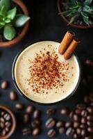 Iced coffee drinks with cinnamon garnish and coffee beans on a dark background photo