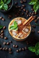 Iced coffee drinks with cinnamon garnish and coffee beans on a dark background photo