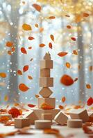 Colorful autumn leaves and wooden toys arranged on a blue background in fall setting photo