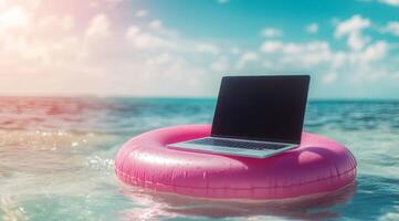 A laptop rests on a pink pool float, bobbing in ocean waves, symbolizing a workaholic lifestyle blending relaxation with work, offering an escape while staying connected to responsibilities photo
