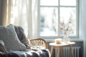 A beautifully serene Scandinavian living space that features a cozy sofa adorned with soft textures, while natural light pours gently through a window, enhancing the inviting atmosphere photo