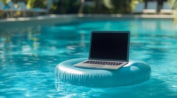 A sleek laptop on a colorful pool float combines leisure and professionalism, inspiring remote workers to boost productivity while enjoying a serene outdoor setting for creativity and motivation photo