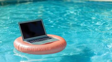 A stylish laptop rests on a colorful pool float, blending work and leisure. Its perfect for modern workaholics seeking tranquility amidst a busy lifestyle, allowing escape while staying productive photo