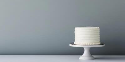 A simple yet elegant white birthday cake on a lovely stand makes the perfect centerpiece for any celebration. Its minimalistic design enhances its charm, making it a delightful treat for all photo