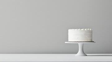 A beautifully simple white birthday cake, which has been elegantly displayed on a classic cake stand, is set against a neutral backdrop, creating a fresh and modern aesthetic that is truly appealing photo