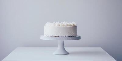 A beautifully crafted and simplistic white birthday cake elegantly presented atop a cake stand, making it an ideal choice for any celebration, characterized by its clean and minimalistic design photo