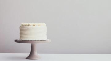 A lovely and simple, yet elegant white birthday cake presented beautifully on a charming cake stand, set against a neutral background, making it perfect for minimalist and refined celebrations photo