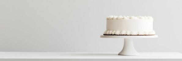 A stunningly minimalistic white birthday cake, elegantly and thoughtfully placed on a beautiful cake stand, making it the perfect centerpiece for any kind of celebration or joyous occasion photo